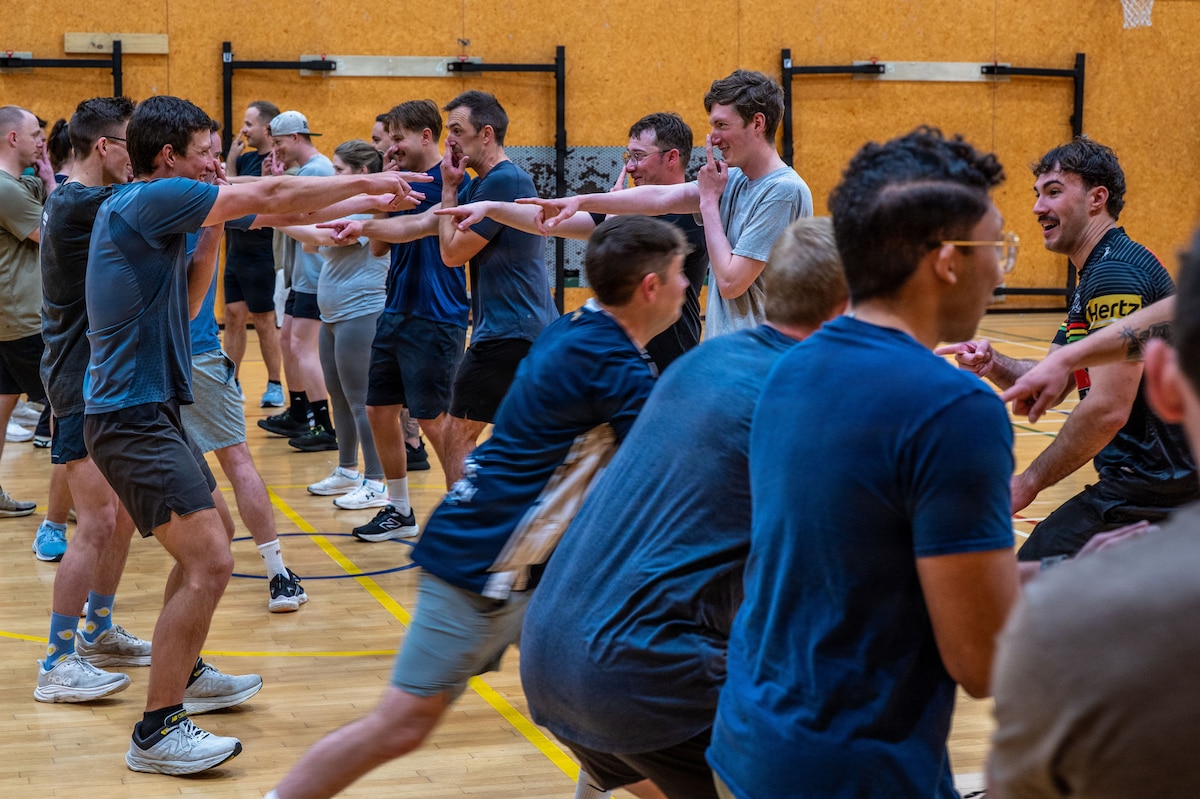 A group of people pointing at each other during a game