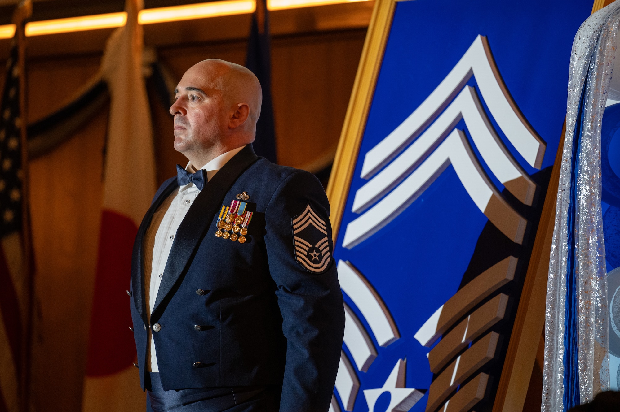 U.S. Air Force Chief Master Sgt. Mathew Challinor, 718th Aircraft Maintenance Squadron superintendent, stands at attention after placing the final chevron of the chief master sergeant rank insignia during a chief induction ceremony at Kadena Air Base, Japan, March 28, 2026. The rank of chief master sergeant is the highest enlisted rank in the Air Force, with only one percent of the enlisted force structure reaching it. (U.S. Air Force photo by Airman 1st Class Francisco Huerta)