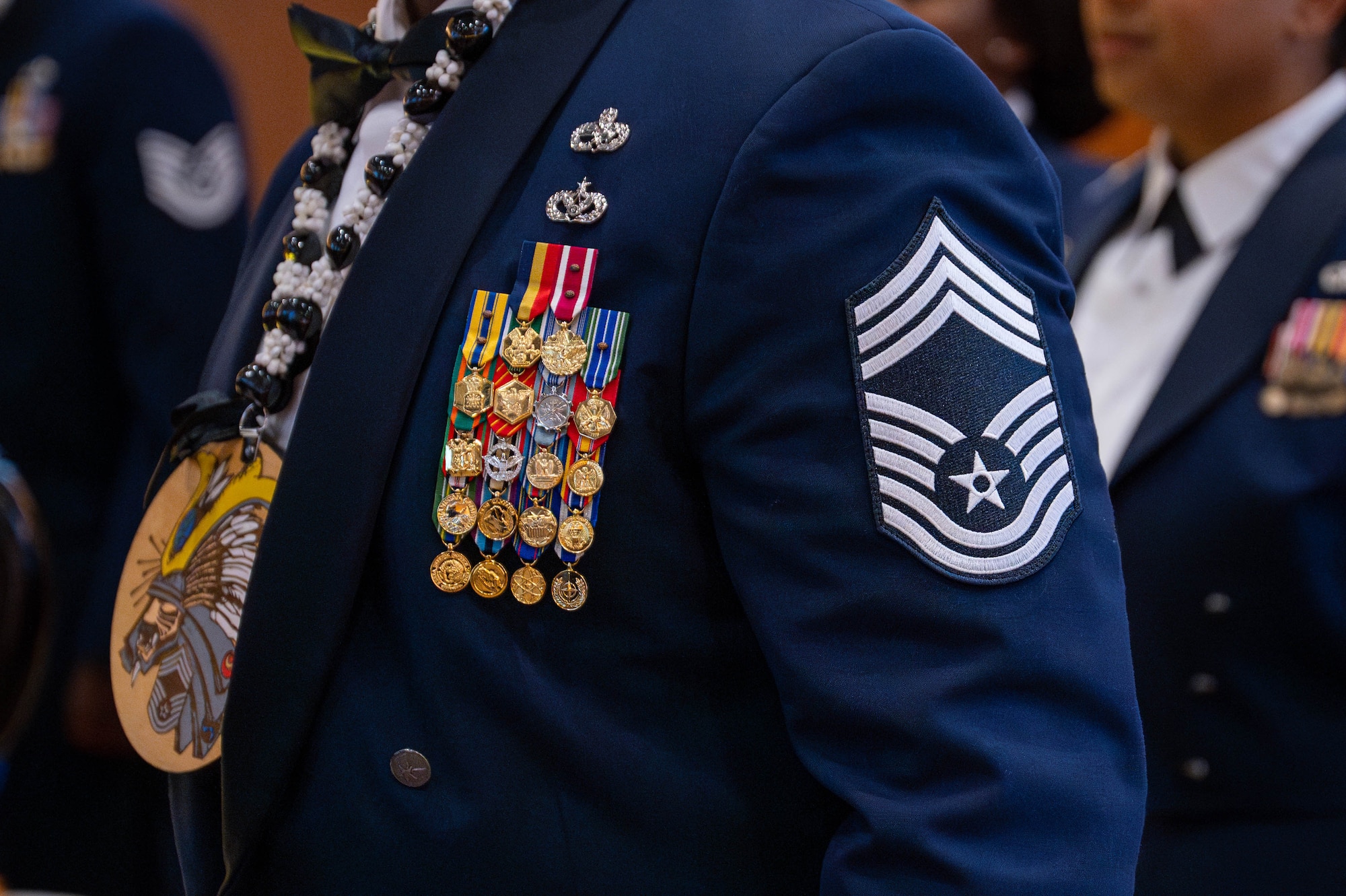 U.S. Air Force chief inductee stands at attention during a chief induction ceremony at Kadena Air Base, Japan, March 28, 2026. This milestone recognizes Airmen who have consistently led at the highest levels and shaped the future of the force. (U.S. Air Force photo by Airman 1st Class Nathaniel Jackson)