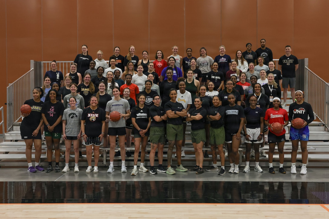 U.S. Marines with Marine Corps Recruiting Command gather with coaches following the Marines "Fit To Win: Morning Workout" session during the 2026 Women’s Basketball Coaches Association.