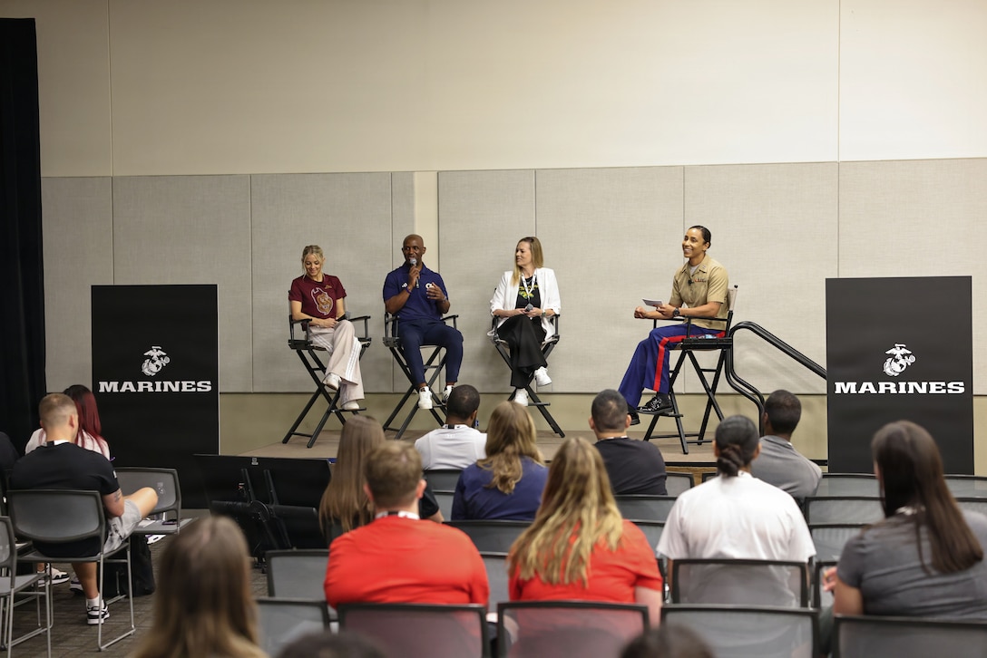 U.S. Marine Corps Capt. Brianna Allen, Marine officer instructor at the University of South Carolina, far right, moderates a panel of approximately 40 coaches including Molly Miller, head women’s basketball coach at Arizona State University, far left, Chris Meadow, assistant women’s basketball coach at Georgia Institute of Technology, left, and Danielle Bishop, head women’s basketball coach at California State Polytechnic University, Pomona, right during the Fit to Win: Building Resilient Teams session at the 2026 Women’s Basketball Coaches Association Convention in Phoenix, April 3, 2026.  The WBCA convention recognizes the work that is essential in building physically and mentally fit youth who are resilient and have the necessary skills to succeed in life. Marine Corps Recruiting Command seeks to connect with coaches through the national partnership program, so they return to their schools and communities better equipped to tell the Marine Corps story, ultimately becoming cornerstone advocates. (U.S. Marine Corps photo by Cpl. Brenna Ritchie)