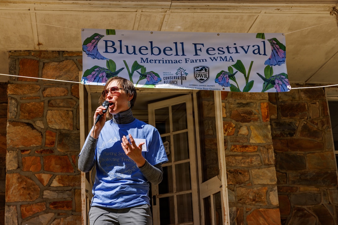 Ashley Studholme, the executive director of the Prince William Conservation Alliance, gives her remarks during the opening ceremony of the annual Bluebell Festival at Merrimac Farm, Nokesville. Virginia, March 29, 2026. The festival highlights the season bloom of Virginia Bluebells and the conservation partnership between Marine Corps Base Quantico and the local environmental organizations. (U.S. Marine Corps photo by Lance Cpl. Federico Marquez)