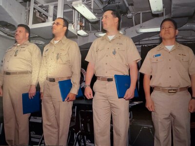 Lt.j.g. Robert ‘Brian’ Conner (second from the left) stands with USS Blue Ridge shipmates in 2006 to accept his Navy Achievement end of tour award.  (Courtesy photo provided by Capt. Conner / RELEASED)