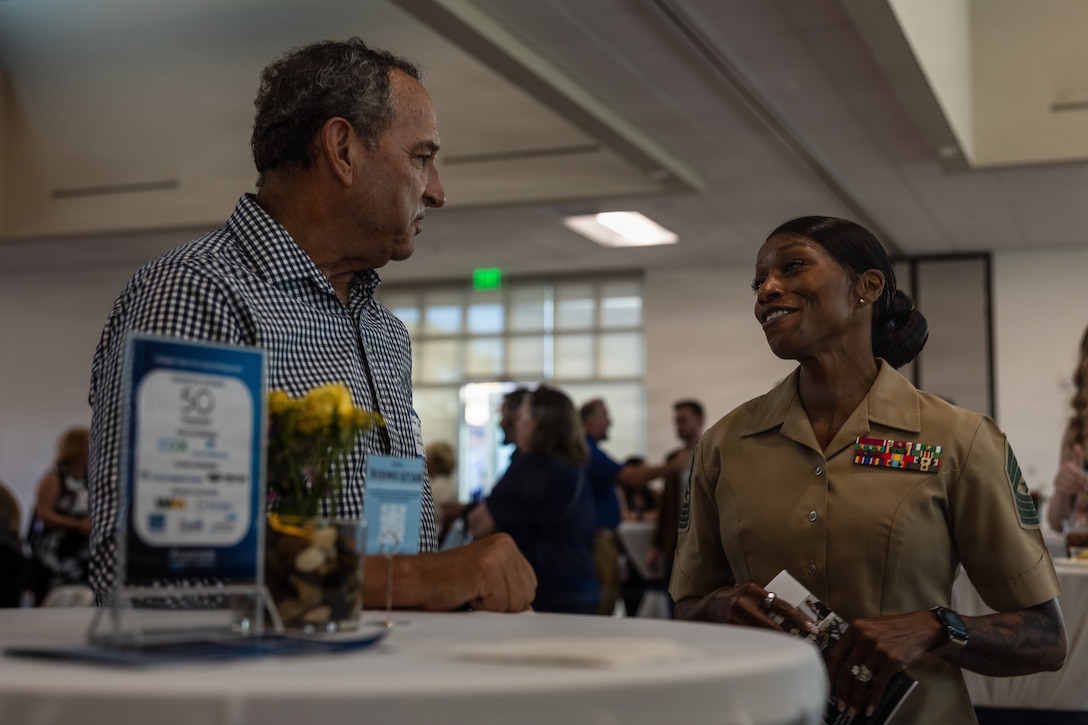 U.S. Marine Corps Sgt. Maj. Cook, senior enlisted leader of Marine Corps Installations West, Marine Corps Base Camp Pendleton, speaks with Mr. Ashton, chief executive officer of Save Oceanside Sand, during the annual Oceanside Chamber of Commerce Meet the City event at the William A. Wagner Aquatic Center in Oceanside, Calif., March 26, 2026. Meet the City brings together business and community leaders, nonprofit executives, city staff, elected officials and leadership with Marine Corps Base Camp Pendleton to engage and gain insight into upcoming city projects, policies and progress. (U.S. Marine Corps photo by Cpl. Martinez)