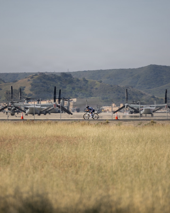 A participant competes in the cycling portion of the IRONMAN 70.3 Oceanside race at Marine Corps Base Camp Pendleton, Calif., March 28, 2026. The race consists of a 1.2-mile swim in Oceanside Harbor, a 56-mile bicycle ride through Marine Corps Base Camp Pendleton and a 13.1-mile run to the Oceanside Pier. The annual event, which travels through a portion of MCB Camp Pendleton, helps the installation maintain strong community relations with the city of Oceanside. (U.S. Marine Corps photo by Sgt. Rafael)