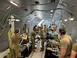 A U.S. Air Force CCATT from BAMC provides simulated medical care to a patient inside a KC-46 Pegasus during a readiness exercise at JBSA-Lackland, Texas.