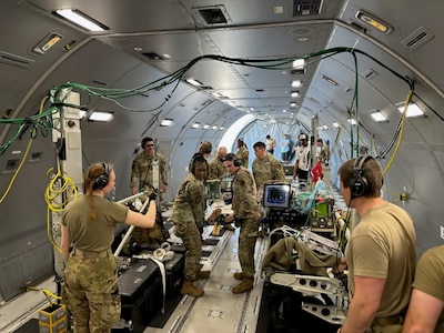 A U.S. Air Force CCATT from BAMC provides simulated medical care to a patient inside a KC-46 Pegasus during a readiness exercise at JBSA-Lackland, Texas.