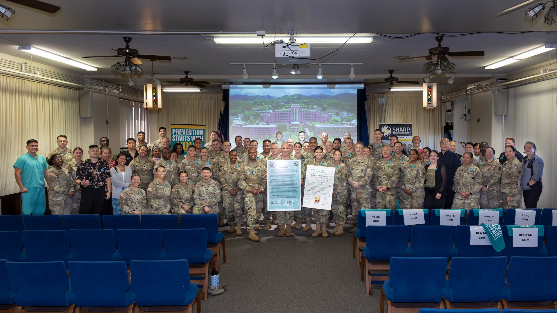 U.S. Army and U.S. Navy leaders from Tripler Army Medical Center (TAMC), Desmond T. Doss Health Clinic (DDHC), and the Soldier Recovery Unit (SRU) join TAMC staff for a group photo during the Sexual Assault Awareness and Prevention Month ceremony held at the Tripler Army Medical Center Chapel on Apr. 1, 2026. The event honored Sexual Assault Awareness and Prevention Month, supporting the campaign theme: “Change through Unity: Empower. Protect. Prevent.” (Defense Health Agency photo by C.J. Caraang)