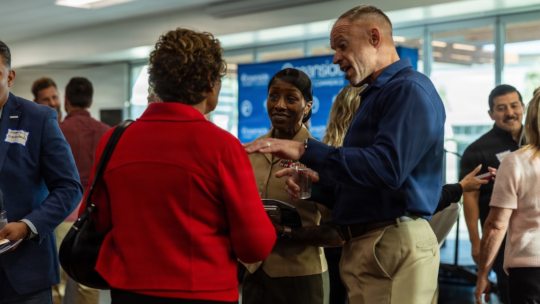 U.S. Marine Corps Sgt. Maj. Cook, center, senior enlisted leader of Marine Corps Installations West, Marine Corps Base Camp Pendleton, and Mr. Whitley, community plans and liaison officer with Marine Corps Installations West, Marine Corps Base Camp Pendleton, right, speak with members of the community during the annual Oceanside Chamber of Commerce Meet the City event at the William A. Wagner Aquatic Center in Oceanside, Calif., March 26, 2026. Meet the City brings together business and community leaders, nonprofit executives, city staff, elected officials and leadership with Marine Corps Base Camp Pendleton to engage and gain insight into upcoming city projects, policies and progress. (U.S. Marine Corps photo by Cpl. Martinez)