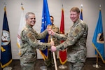 Lt. Gen. John J. DeGoes, Air Force Surgeon General and commander, Air Force Medical Command, hands the guidon to Brig. Gen. Robert K. Bogart during a change of command ceremony for Medical Readiness Command Alpha in San Antonio, Texas, April 1, 2026. Bogart is also assuming duties as the director of Defense Health Network Central, responsible for the oversight of health care delivery in 39 military treatment facilities and 45 dental treatment facilities across four Air Force major commands, two Army hospitals, and one Navy clinic. (DoW photo by Jason W. Edwards)