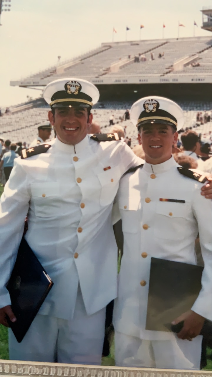 John E. Dougherty IV, right, celebrates with classmate Bubba Palazza at their 1995 U.S. Naval Academy graduation.