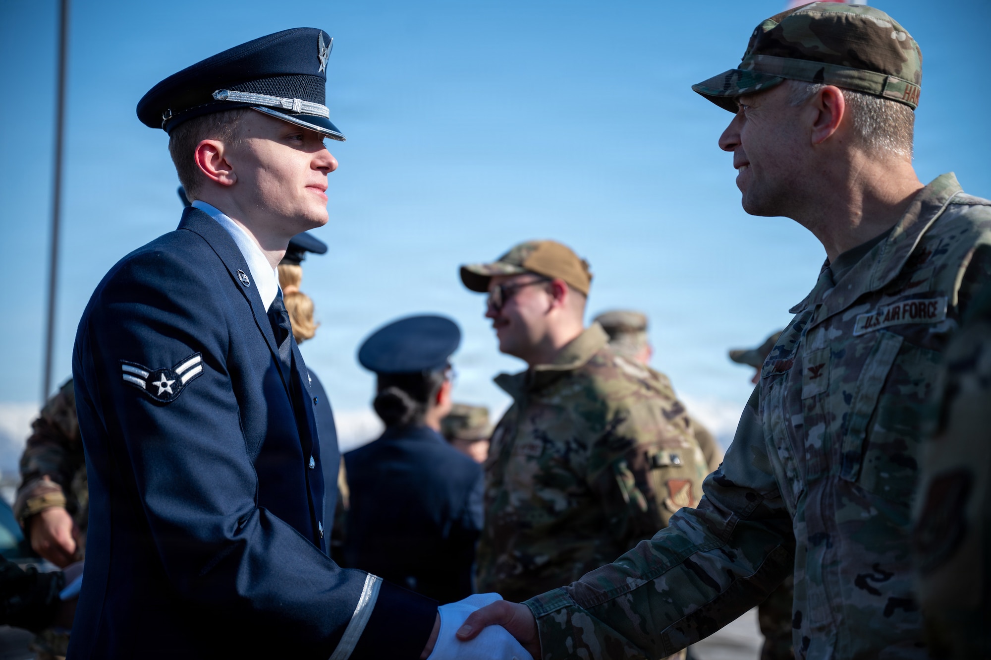 U.S. Air Force Airman 1st Class Kaden Hawley, a Joint Base Elmendorf-Richardson Honor Guard graduate, receives a congratulatory handshake from Col. Dustin Hansen, 673d Mission Support Group commander, during an honor guard graduation ceremony on JBER, Alaska, March 31, 2026. Airmen from a multitude of different units on JBER volunteer and compete against their peers to serve in the Honor Guard, with only the best to represent the installation.