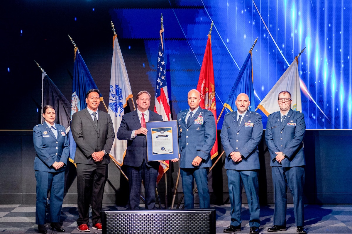 Space Systems Command’s Systems Delta 88 SATCOM receives the U.S. Department of War’s highest acquisition team award March 19, 2026 at the Warfighting Acquisition University in Fort Belvoir, Virginia. Pictured from left to right are: Lt. Col. Laila Barasha, Conrad Chong, Michael P. Duffy, undersecretary of war for acquisition and sustainment, Col. A.J. Ashby, Lt. Col. Kevin Springer, and Maj. Dale Hartley.