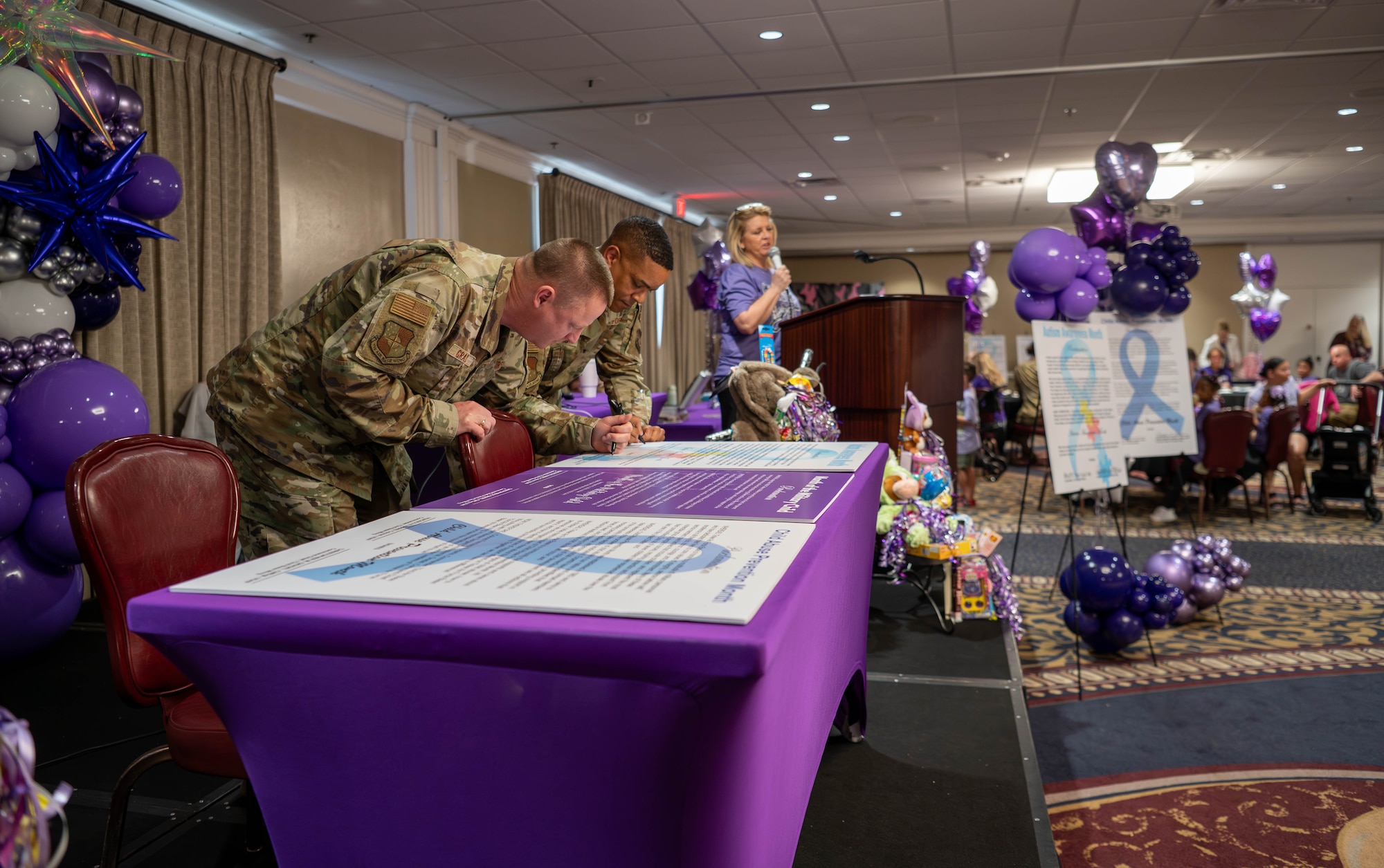 Two men signing documents on table
