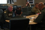 Maj. Gen. Charles D. Bolton, Eighteenth Air Force commander, left, speaks with Lt. Col. Steven Radtke, 433rd Operations Support Squadron director of operations, middle, and Lt. Col. Christopher G. Jones, 356th Airlift Squadron commander, right, during a visit at Joint Base San Antonio-Lackland, Texas, March 4, 2026. Bolton met with members of the flying squadron to learn about the C-5 Formal Training Unit and discuss how senior leadership can better support the squadron’s mission, readiness, and personnel. (U.S. Air Force photo by Tech. Sgt. Adriana Barrientos)