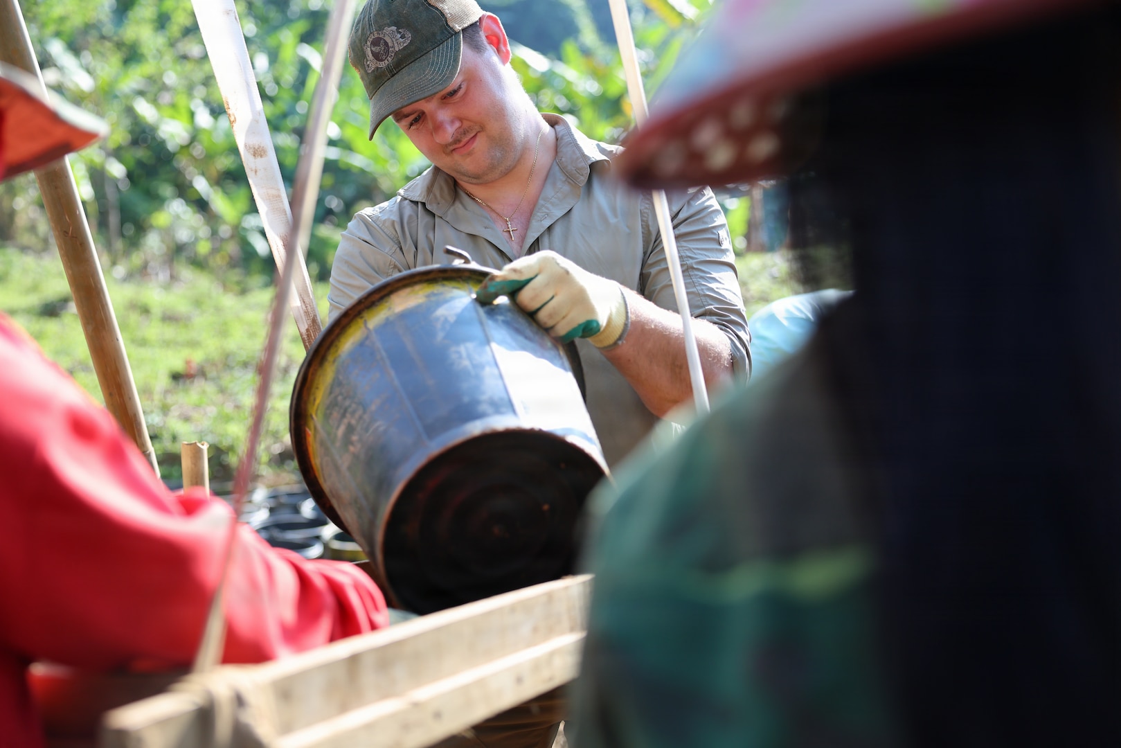 U.S. Air Force Tech. Sgt. Zachary De Marco, an explosive ordnance disposal technician for Recovery Team 3, part of Defense POW/MIA Accounting Agency Joint Field Activity 26-3LA, cleans a bucket in preparation to dry-screen potential evidence at a recovery site in Laos, March 24, 2026.