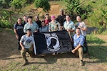 Team members of Recovery Team 3, part of Defense POW/MIA Accounting Agency Joint Field Activity 26-3LA, pose for a group photo with the POW/MIA flag at the end of recovery operations in Laos, March 27, 2026.