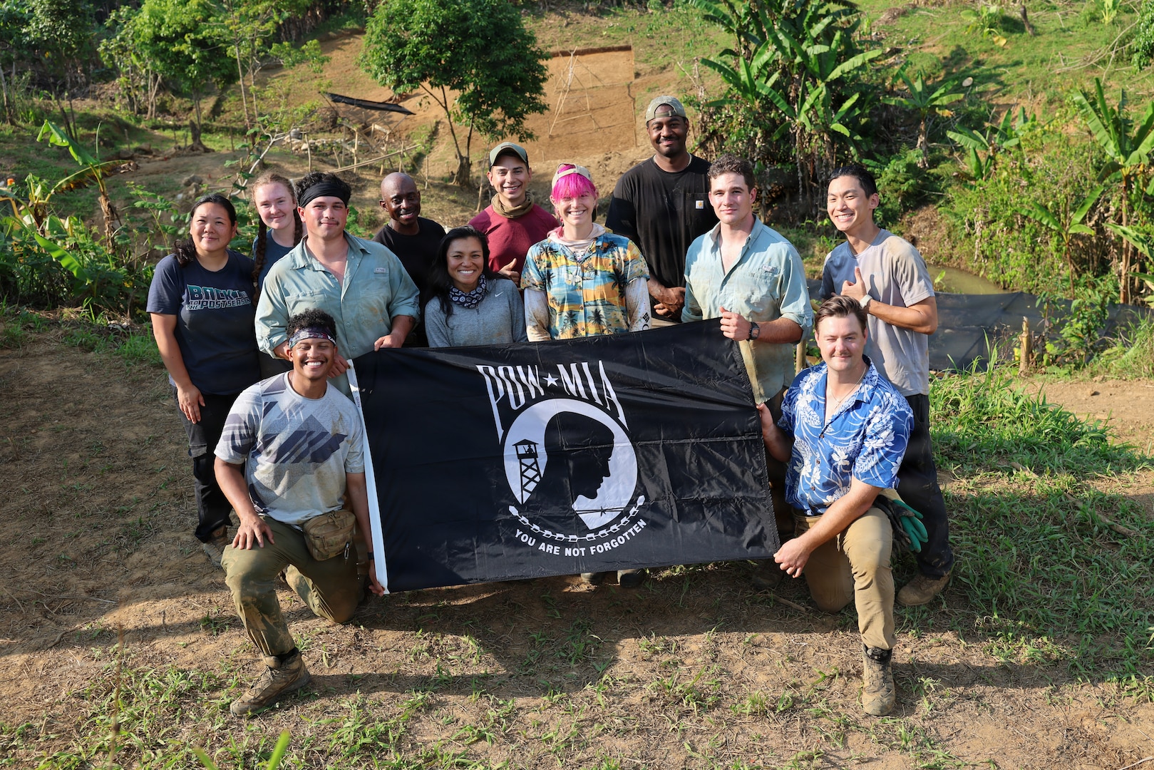 Team members of Recovery Team 3, part of Defense POW/MIA Accounting Agency Joint Field Activity 26-3LA, pose for a group photo with the POW/MIA flag at the end of recovery operations in Laos, March 27, 2026.