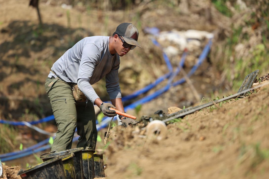 U.S. Air Force Staff Sgt. Aaron Chandleur, an explosive ordnance disposal technician for Recovery Team 3, part of Defense POW/MIA Accounting Agency Joint Field Activity 26-3LA, investigates a potential medal hit in a unit at a recovery site in Laos, March 23, 2026.