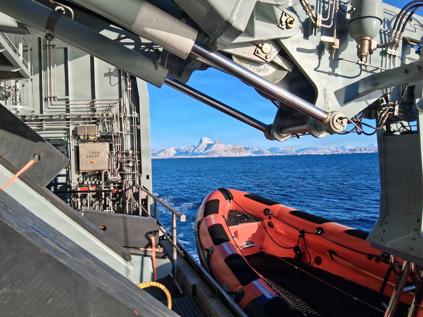 260221-N-N0736-1001 NUUK, Greenland (Feb. 21, 2026) – A rigid-hull inflatable boat is deployed from the Royal Danish Navy offshore patrol vessel HDMS VAEDDEREN (F 359) in preparation for a personnel transfer from the Virginia-class fast-attack submarine USS Delaware (SSN 791). Delaware is operating in the U.S. Naval Forces Northern Command (NAVNORTH) area of operations. (Courtesy photo.)