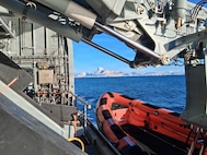 260221-N-N0736-1001 NUUK, Greenland (Feb. 21, 2026) – A rigid-hull inflatable boat is deployed from the Royal Danish Navy offshore patrol vessel HDMS VAEDDEREN (F 359) in preparation for a personnel transfer from the Virginia-class fast-attack submarine USS Delaware (SSN 791). Delaware is operating in the U.S. Naval Forces Northern Command (NAVNORTH) area of operations. (Courtesy photo.)