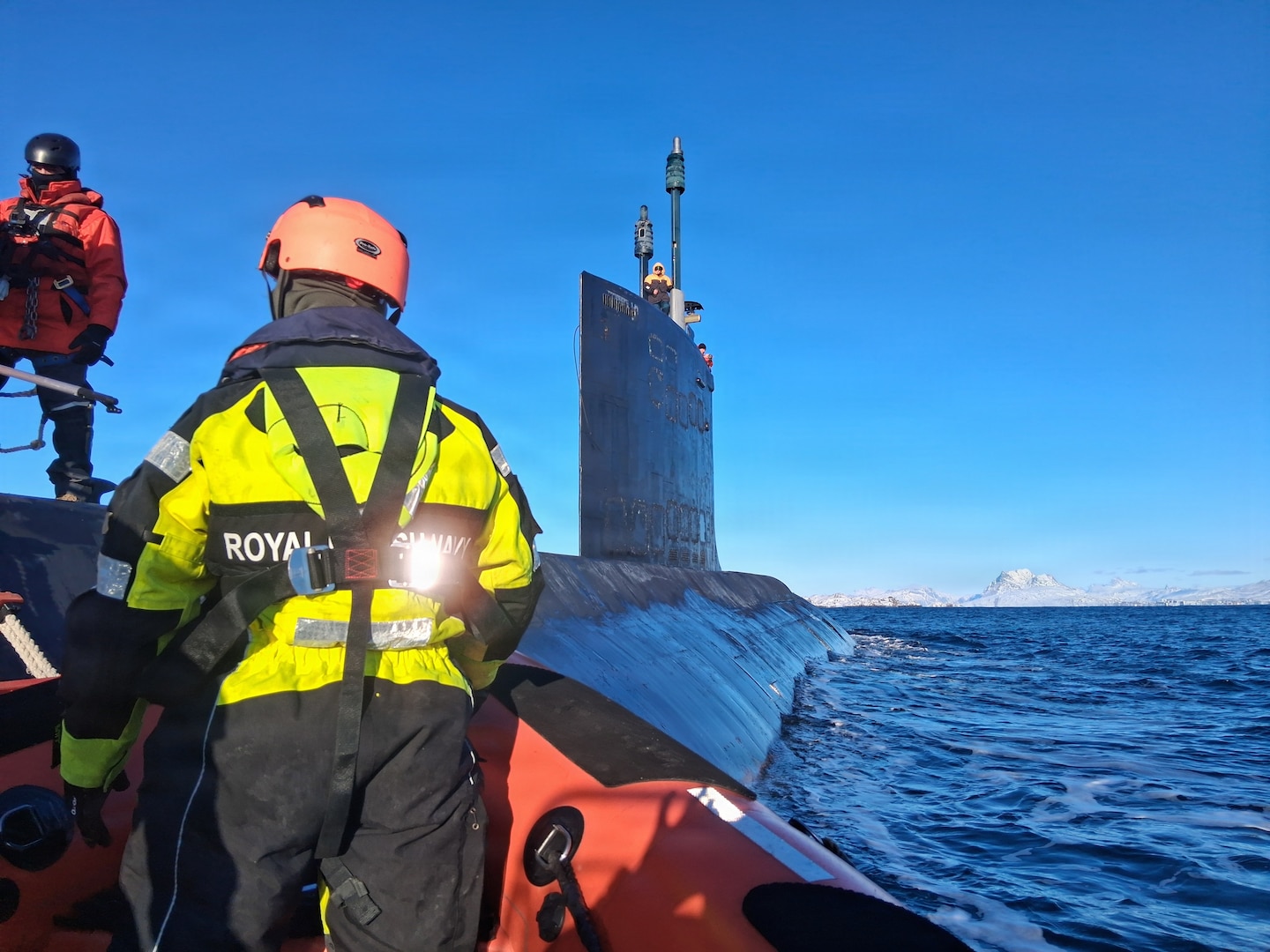 260221-N-N0736-1002 NUUK, Greenland (Feb. 21, 2026) – A rigid-hull inflatable boat from the Royal Danish Navy offshore patrol vessel HDMS VAEDDEREN (F 359) approaches the Virginia-class fast-attack submarine USS Delaware (SSN 791) during a personnel transfer. Delaware is operating in the U.S. Naval Forces Northern Command (NAVNORTH) area of operations. NAVNORTH is the maritime component of U.S. Northern Command (USNORTHCOM) and is responsible for homeland defense, maritime security, and theater security cooperation in the Arctic and North American maritime approaches. (Courtesy photo)