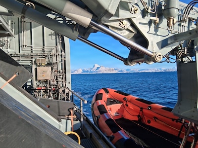 260221-N-N0736-1001 NUUK, Greenland (Feb. 21, 2026) – A rigid-hull inflatable boat is deployed from the Royal Danish Navy offshore patrol vessel HDMS VAEDDEREN (F 359) in preparation for a personnel transfer from the Virginia-class fast-attack submarine USS Delaware (SSN 791). Delaware is operating in the U.S. Naval Forces Northern Command (NAVNORTH) area of operations. (Courtesy photo.)
