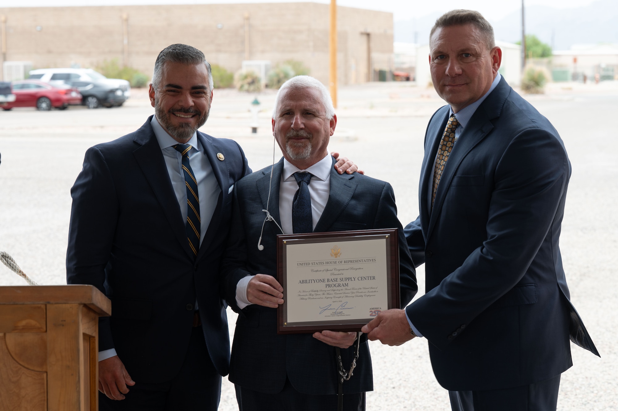 U.S. Rep. Juan Ciscomani, left,  presents David Steinmetz, Arizona Industries for the Blind public relations manager, center, and Chris LaFollette, AIB president, a Certificate of Special Congressional Recognition during the AbilityOne Base Supply Center 30th Anniversary Ceremony at Davis-Monthan Air Force Base, Arizona, April 6, 2026. The recognition honored AIB for its continued support of the AbilityOne Program and service to DM. (U.S. Air Force photo by Airman 1st Class Jaden Kidd)