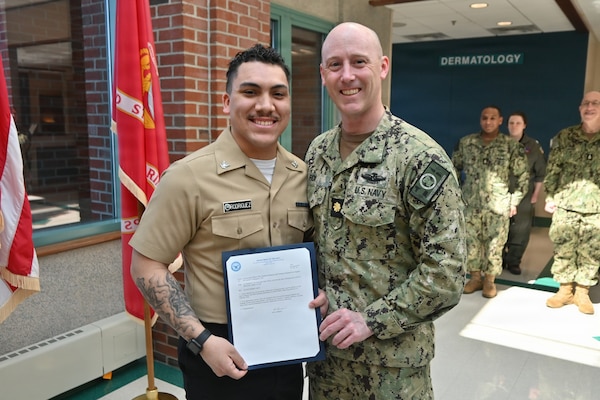260317-N-OV429-1001 NEWPORT, R.I. (Mar. 17, 2026) Hospital Corpsman Third Class Samuel Rodriguez, assigned to Navy Medicine Readiness and Training Command (NMRTC) New England is presented with a frocking letter to the rank of Petty Officer 3rd Class, by Lt. Cmdr. Ryan Fick, division officer, medical readiness clinic, during a promotion ceremony held at Naval Health Clinic New England, Newport, R.I., Mar. 10, 2026. NMRTC New England provides operational training to healthcare professionals through healthcare delivery to optimize both medical staff and Warfighter and readiness. (U.S. Navy photo by Lieutenant Sydney Wall)