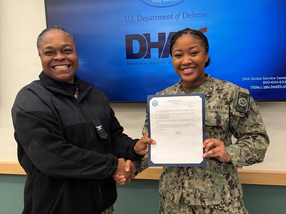 260318-N-OV429-1001 NEWPORT, R.I. (Mar. 18, 2026) Capt. Rona Green, commanding officer, Navy Medicine Readiness and Training Command (NMRTC) New England presents Hospital Corpsman 3rd Class Lydia Horne authorization to assume and wear the uniform of a Petty Officer 3rd Class during a meritorious advancement, held at Naval Health Clininc New England, Newport, R.I., Mar. 10, 2026. NMRTC New England provides operational training to healthcare professionals through healthcare delivery to optimize both medical staff and Warfighter and readiness. (U.S. Navy photo by Lieutenant Sydney Wall).