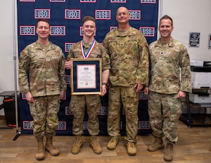 A group of men pose for a photo.
