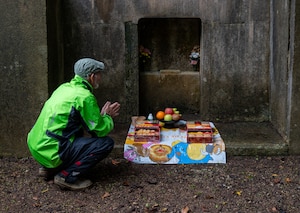 A local Okinawan prays to an ancestral tomb during Shimi at Kadena Air Base, Japan.