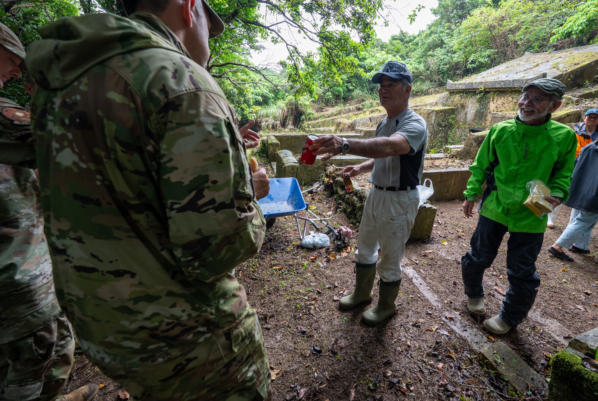 A local Okinawan family shares food and drinks with Airmen from the 18th Munitions Squadron during Shimi at Kadena Air Base, Japan.