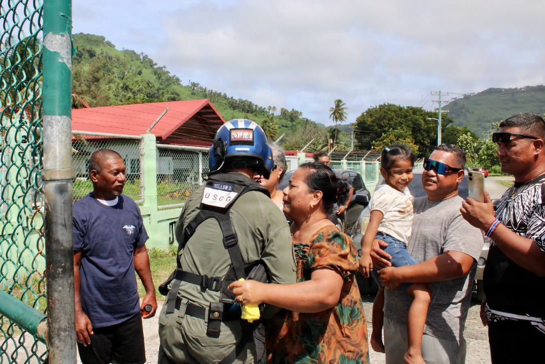 U.S. Coast Guard Petty Officer 3rd Class James Warguez is embraced by members of a family rescued by the crew of Legend-class cutter USCGC Midgett (WMSL 757) in the waters of Chuuk State, Federated States of Micronesia, after being reunited with loved ones upon their safe return via U.S. Coast Guard MH-65 Dolphin helicopter to Weno, Chuuk State on April 6, 2026. The crew of Midgett rescued the family on April 6 after their 23-foot single-outboard skiff vessel went missing a week earlier in the waters of Chuuk State. U.S. Coast Guard missions in the Indo-Pacific focus on issues that directly support and advance our regional partners’ efforts to protect fish stocks and ensure the safety of life at sea, helping to ensure a secure and prosperous Indo-Pacific. (U.S. Coast Guard photo by Lt. Doug Brown)