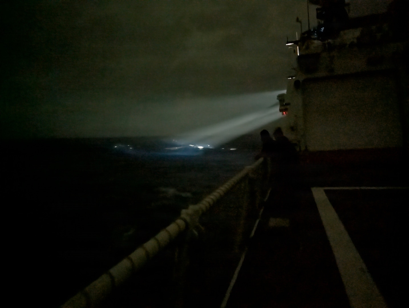 Bridge watchstanders aboard the Legend-class cutter USCGC Midgett (WMSL 757) locate a 23-foot single-outboard skiff vessel carrying three members of a missing family in the waters of Chuuk State, Federated States of Micronesia, during the early hours of April 6, 2026. The crew of Midgett rescued the family after the vessel went missing on March 30 in the waters of Chuuk State. (U.S. Coast Guard photo by Seaman Lauren Taber)