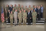 DLA leadership pose for a photo on risers