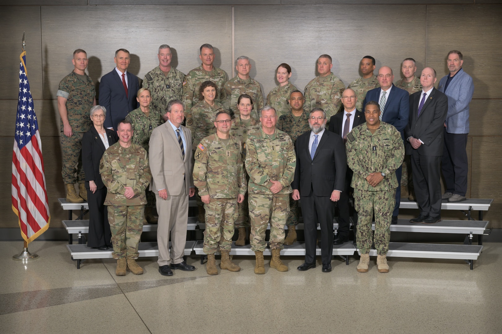DLA leadership pose for a photo on risers