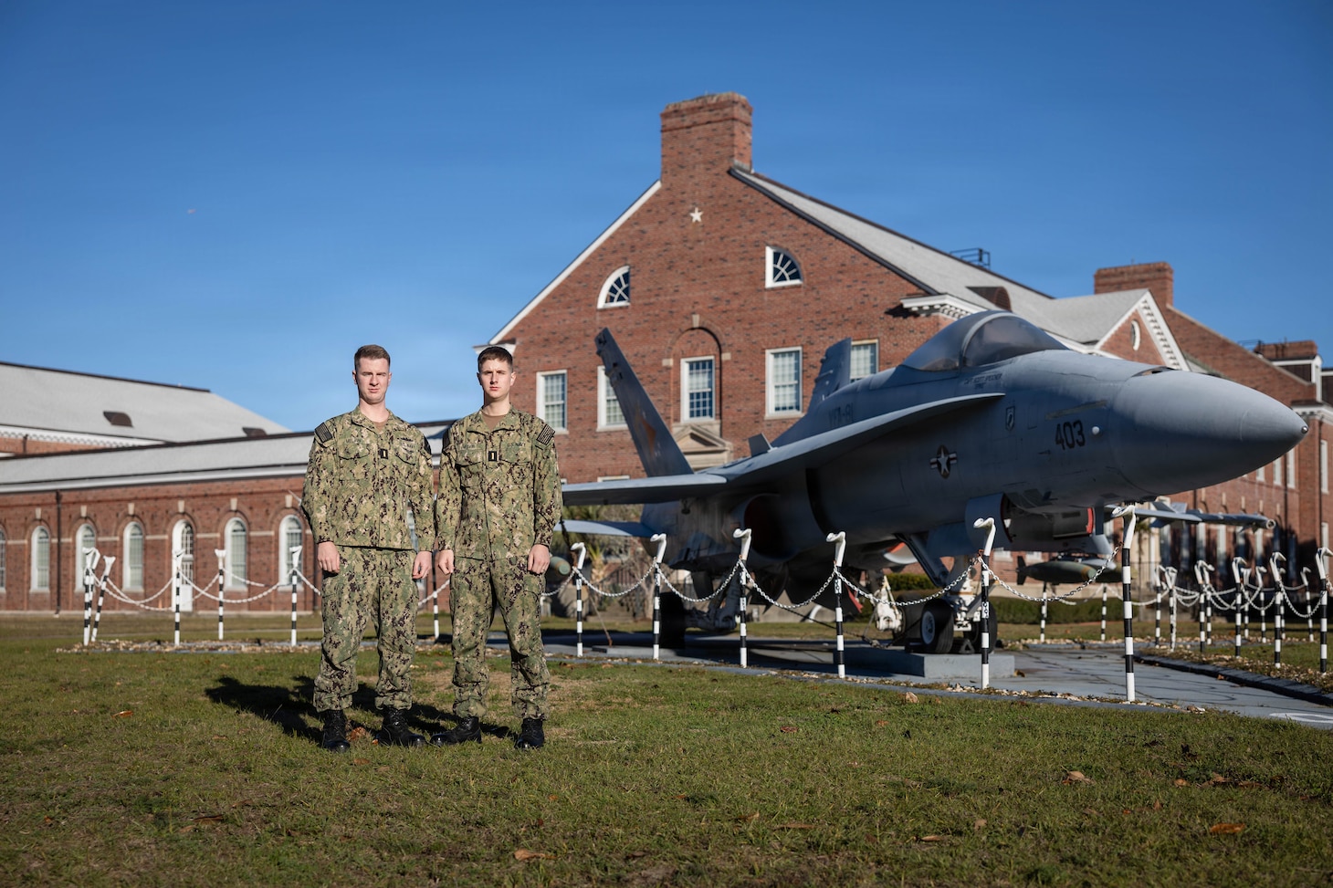 Ensign Zachary Melvin (left) and Ensign Samuel Melvin, brothers serving in the U.S. Navy, pose for a photo at Naval Aviation Schools Command onboard Naval Air Station Pensacola, in Pensacola, Fla. The Melvin brothers’ shared commitment to service highlights the Navy’s emphasis on family, teamwork, and professionalism across the fleet.