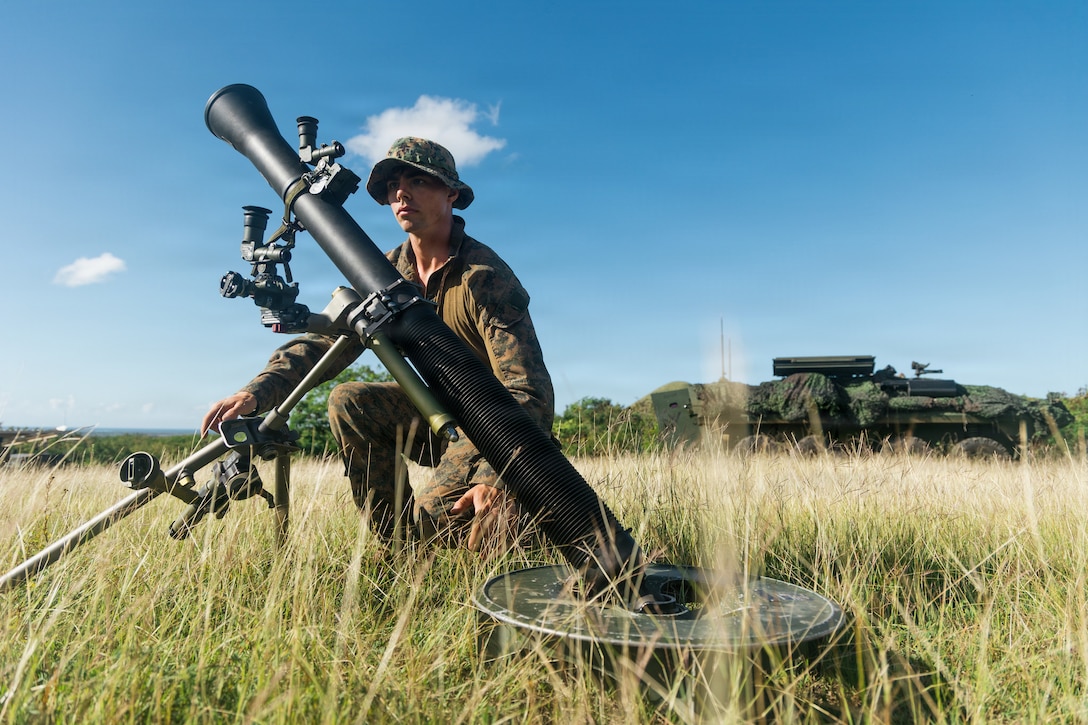 A U.S. Marine Corps mortarman with Light Armored Reconnaissance, Battalion Landing Team 3/6, 22nd Marine Expeditionary Unit (Special Operations Capable), sets up an M1A2 81mm Mortar System during a light-armored vehicle mounted mortar system live-fire range at Camp Santiago, Puerto Rico, March. 30, 2025. U.S. military forces are deployed to the Caribbean in support of the U.S. Southern Command mission, Department of War-directed operations, and the president’s priorities to disrupt illicit drug trafficking and protect the homeland. (U.S. Marine Corps photo)