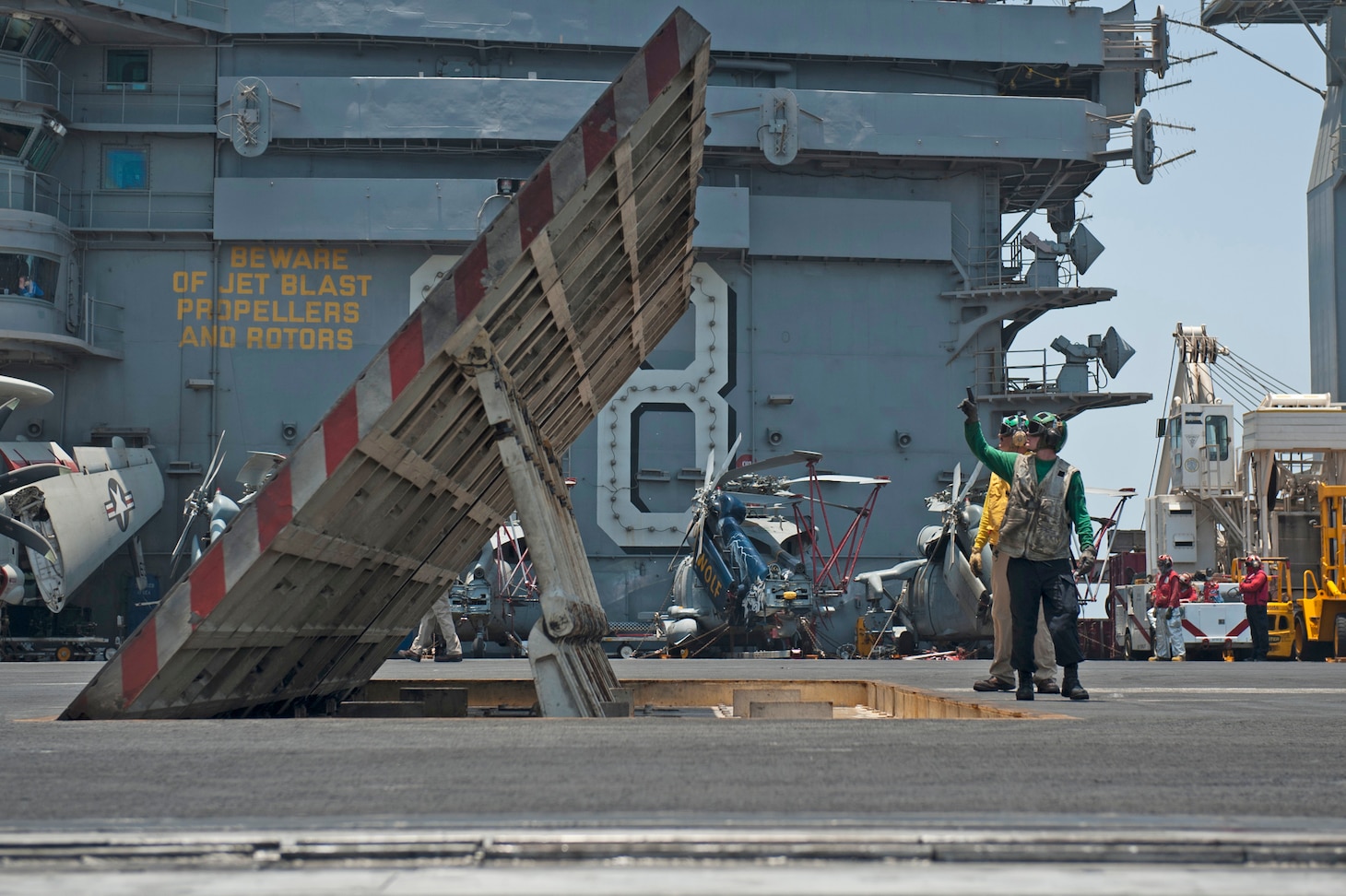 U.S. sailors inspect jet blast deflectors aboard the aircraft carrier USS Nimitz (CVN 68) in the Persian Gulf July 10, 2013. The Nimitz was underway in the U.S. 5th Fleet area of responsibility supporting maritime security operations and theater security cooperation efforts.