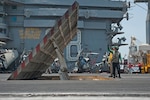 U.S. sailors inspect jet blast deflectors aboard the aircraft carrier USS Nimitz (CVN 68) in the Persian Gulf July 10, 2013. The Nimitz was underway in the U.S. 5th Fleet area of responsibility supporting maritime security operations and theater security cooperation efforts.