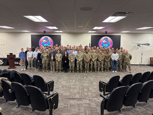 Airmen, government civilians, and industry partners pose for a photo during the annual J-Hack 26-1 coding event Jan. 30, 2026. The event is an Air Combat Command-sponsored event designed to develop software solutions for command and control, intelligence, surveillance, and reconnaissance operational needs by connecting intelligence tool users and developers. During the event, the Department of the Air Force Portfolio Acquisition Executive for Command, Control, Communications and Battle Management’s C2ISR division developed a minimum viable product that assists with automated target recognition. (Official Air Force Courtesy photo).