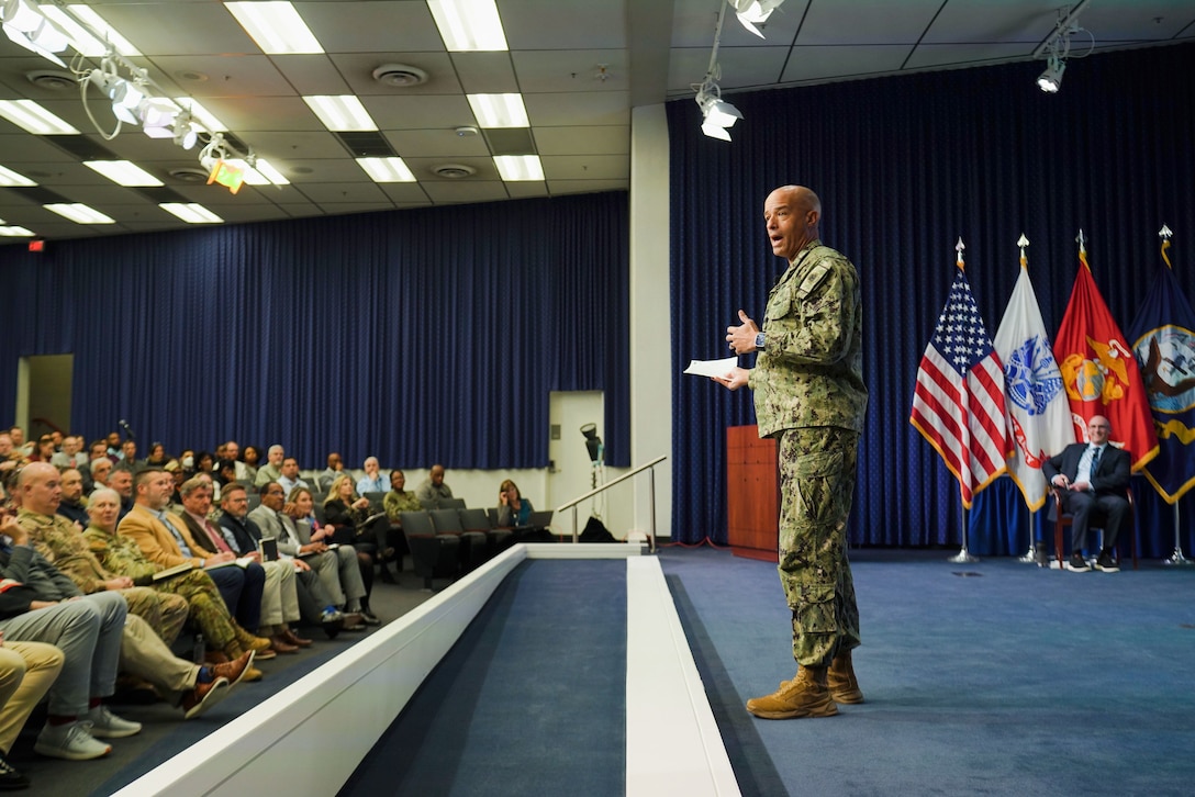 briefing an audience from a stage