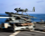 A Textron MQ-19 Aerosonde Unmanned Aircraft System launches from the expeditionary sea base USS Hershel “Woody” Williams (ESB-4).