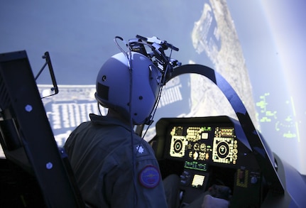 A pilot operates a simulator inside the Naval Air Warfare Center Aircraft Division’s Joint Simulation Environment at Naval Air Station Patuxent River, Md. The JSE enables pilots to train in highly realistic virtual combat scenarios, sharpening their skills and improving readiness.