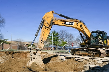 Dave Newman, field supervisor for TTI Environmental Inc, operates an excavator on Joint Base Anacostia-Bolling, Washington, D.C., March 26,2026. The heavy equipment operators removed debris for the replacement of aging fuel lines, resulting in increased safety and improved quality of life on the base. (U.S. Air Force photo by Senior Airman Shanel Toussaint)