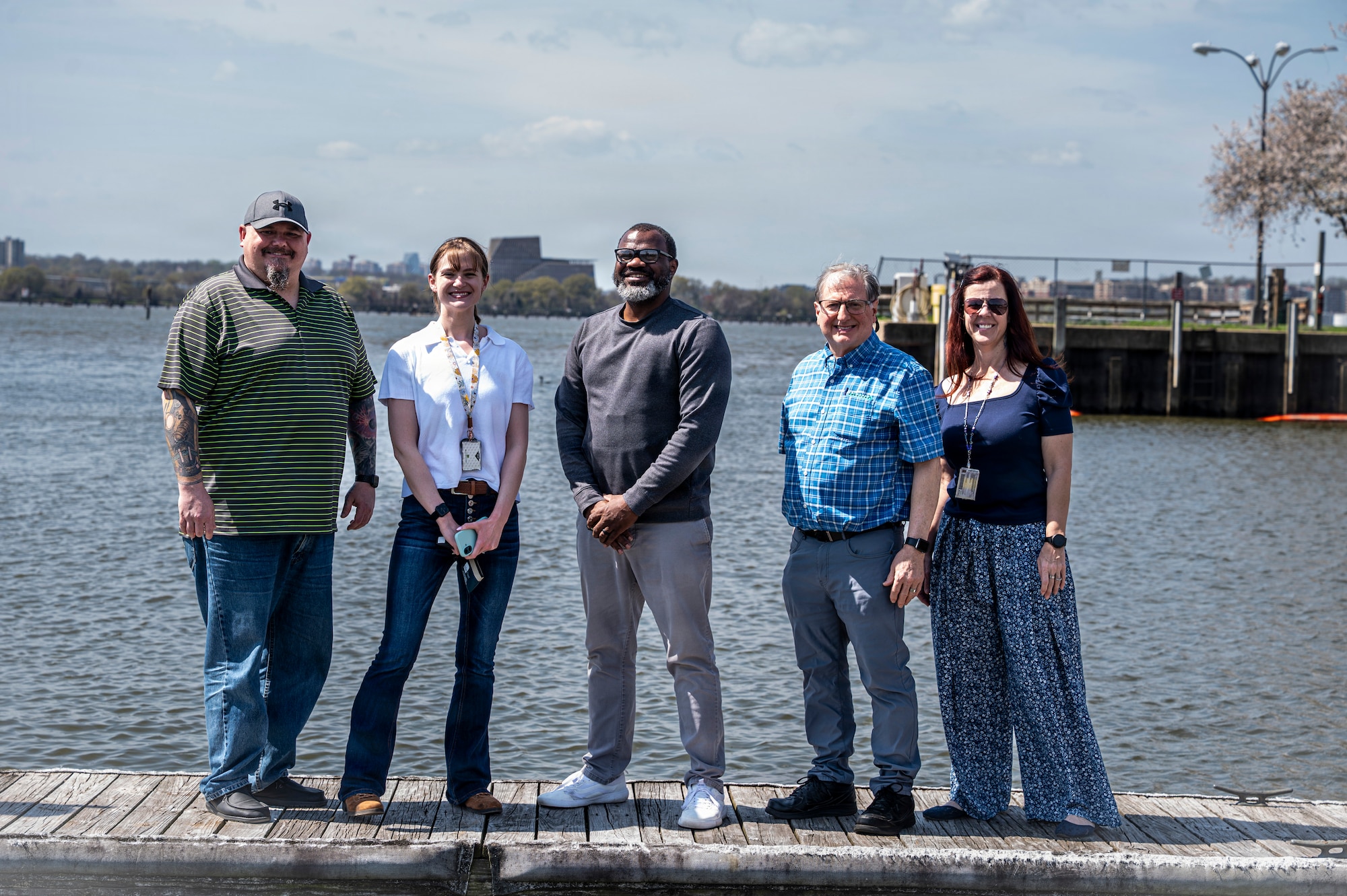 The U.S. Air Force’s 11th Civil Engineer Squadron’s environmental compliance team poses for a group photo on the waterfront at Joint Base Anacostia-Bolling, Washington, D.C., March 31, 2026. The team reviewed plans and guided inspection processes throughout the recent construction project to revitalize the base gas station, which ensured JBAB’s compliance with long-term environmental standards. (U.S. Air Force photo by Senior Airman Shanel Toussaint)