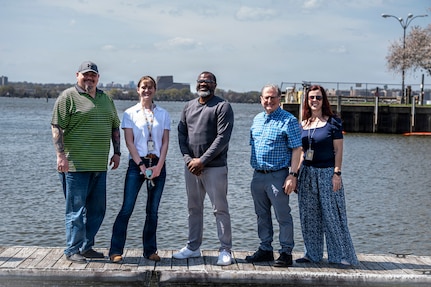 The U.S. Air Force’s 11th Civil Engineer Squadron’s environmental compliance team poses for a group photo on the waterfront at Joint Base Anacostia-Bolling, Washington, D.C., March 31, 2026. The team reviewed plans and guided inspection processes throughout the recent construction project to revitalize the base gas station, which ensured JBAB’s compliance with long-term environmental standards. (U.S. Air Force photo by Senior Airman Shanel Toussaint)