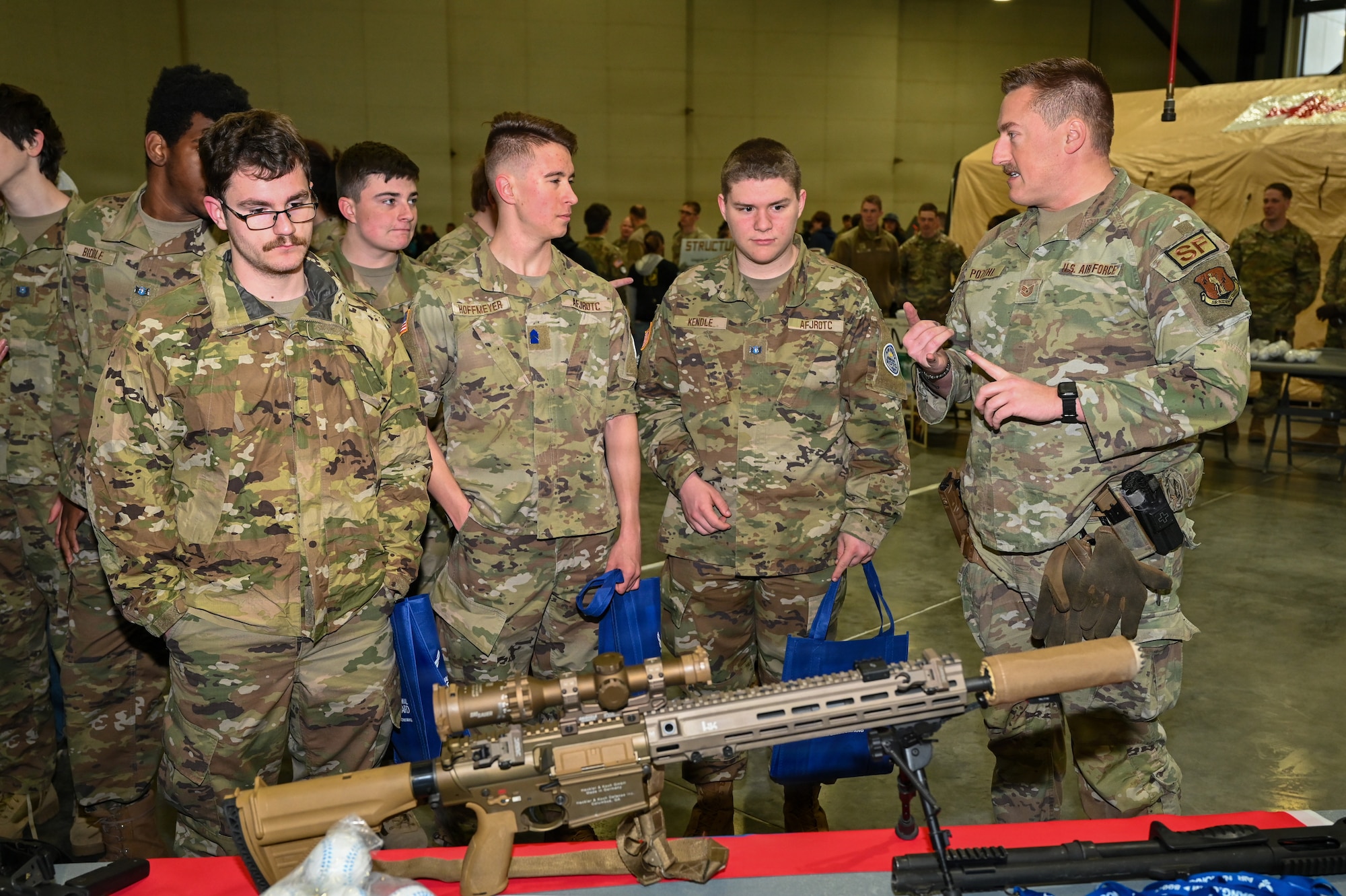 Tech. Sergeant Sean Pozehl, 155th Security Forces Squadron combat arms training and maintenance instructor, showcases weapons systems and capabilities to students during the 155th Air Refueling Wing’s Open Hangar, April 1, 2026, at the Nebraska National Guard air base in Lincoln, Nebraska. Pozehl explained some of the skills required to be a Security Forces professional in the Air National Guard. (U.S. Air National Guard photo by Tech. Sgt. Phil Cowen)