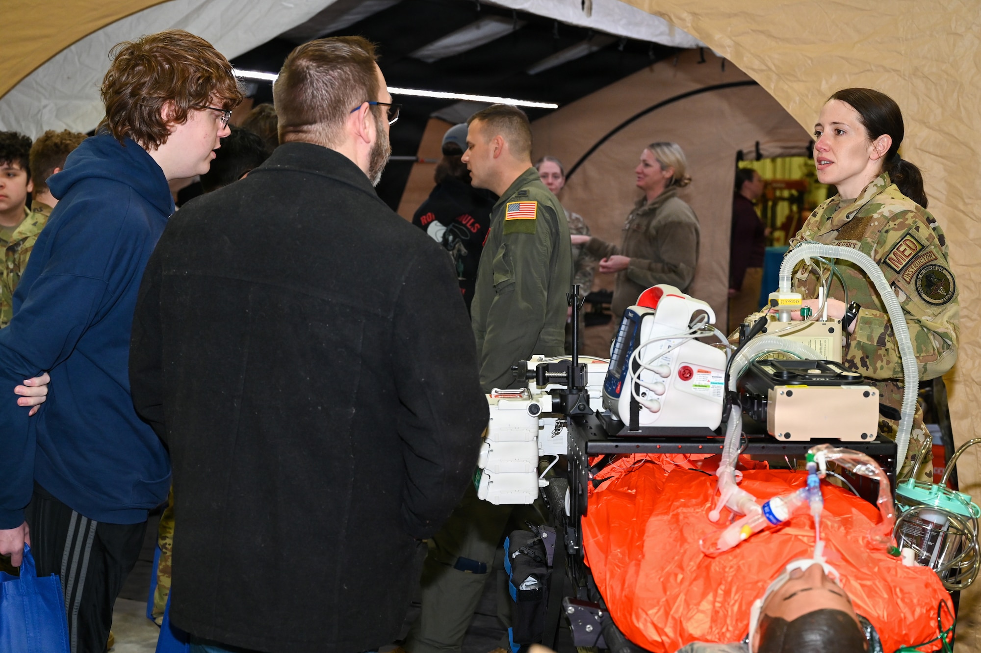 Master Sergeant Amber Obregon, 155th Medical Group respiratory care practitioner, discusses the various missions of the Nebraska Air National Guard with students and families during the 155th Air Refueling Wing’s Open Hangar, April 1, 2026, at the Nebraska National Guard air base in Lincoln, Nebraska. Students that visited the medical area learned about Critical Care Air Transport Teams and Chemical, Biological, Radiological, Nuclear, and high-yield Explosive Enhanced Response Force Package; two specialized missions carried out at the 155th Air Refueling Wing. (U.S. Air National Guard photo by Tech. Sgt. Phil Cowen)